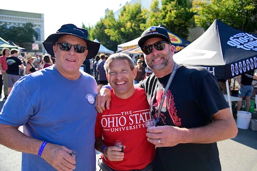 Three men posing together at the beer fest event, with one wearing a red 'The Ohio State University' shirt.