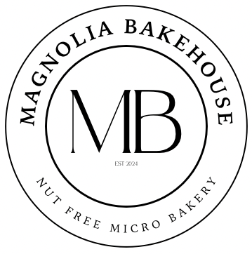 Magnolia Bakehouse logo with 'MB' initials in the center of a circle, with Magnolia Bakehouse text rounded on top of the circle and Nut Free Micro Bakery in text rounded on the bottom - rounded text within an outside circle.  Black text on a white background.  