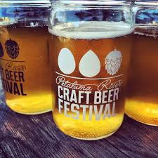 Two glasses of beer with 'Craft Beer Festival' text on a wooden surface