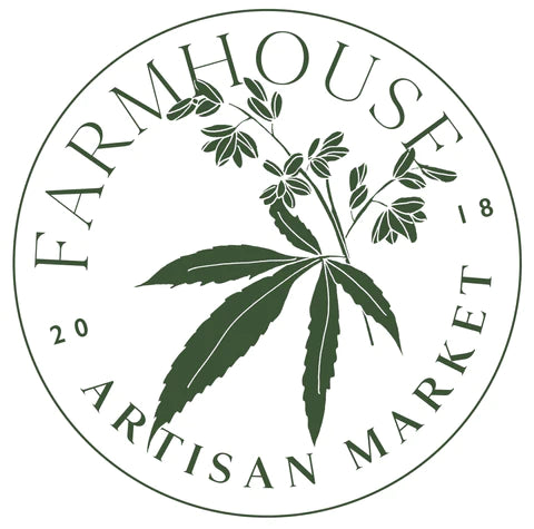 A circular logo for Farmhouse Artisan Market featuring a dark green cannabis leaf illustration in the center, with the words 'FARMHOUSE' arched at the top and 'ARTISAN MARKET' curved at the bottom on a white background.
